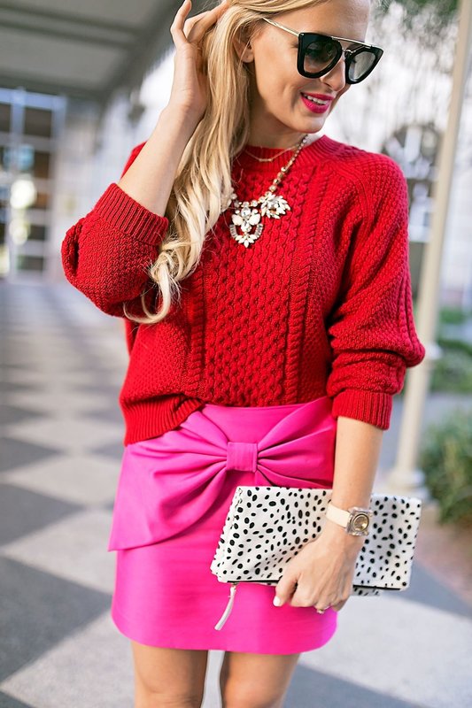 Girl in a red sweater and a pink skirt