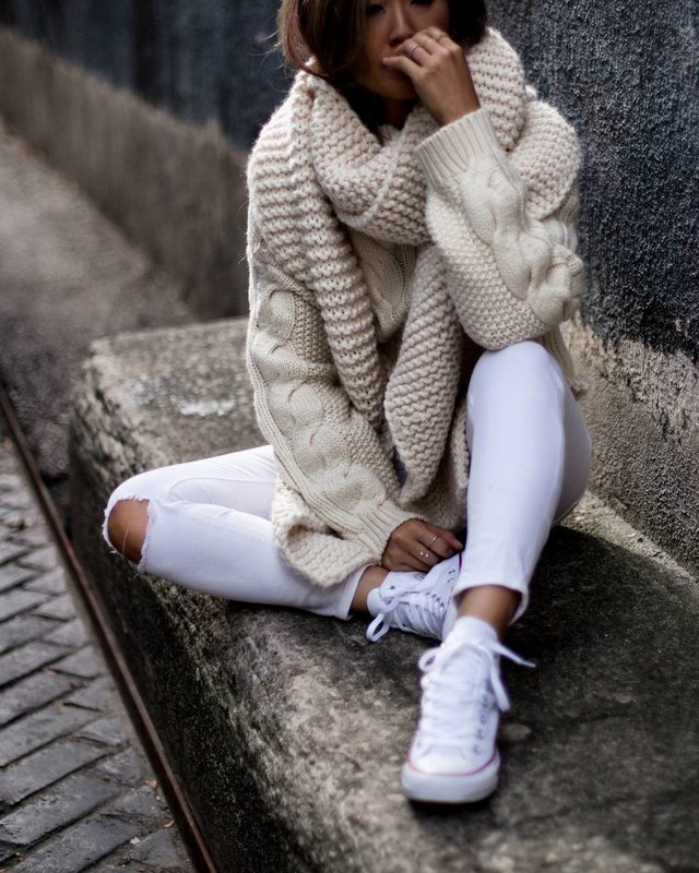 Girl in a large knit sweater and a wide collar