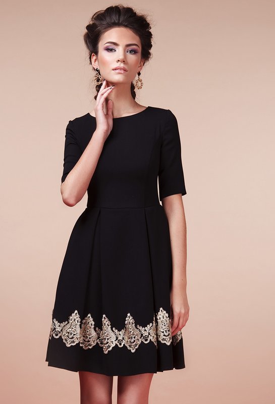 Girl in a black A-line cocktail dress with lace insert