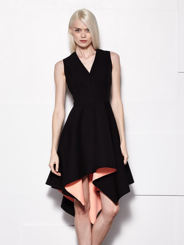 Girl in a black cocktail dress with asymmetry