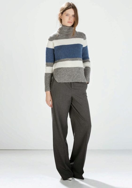 Girl in a horizontal striped sweater and trousers.