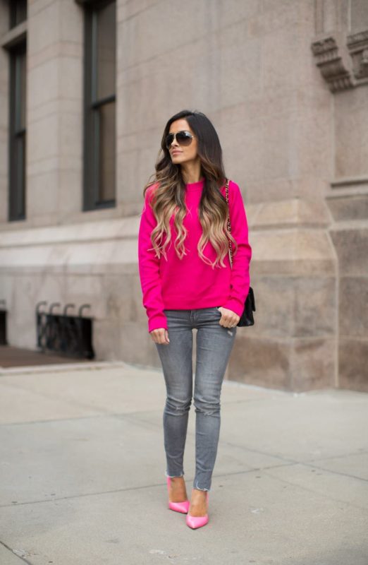 Girl in a bright pink sweater and skinny jeans