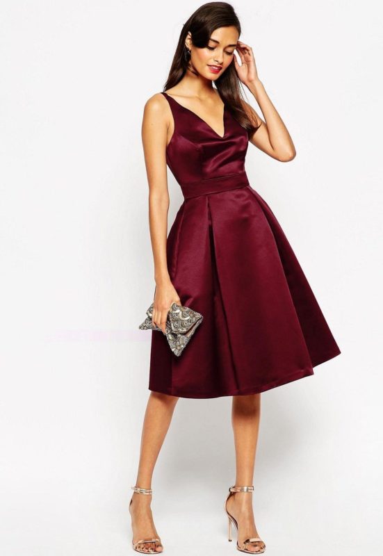 Girl in a burgundy cocktail dress with a deep neckline