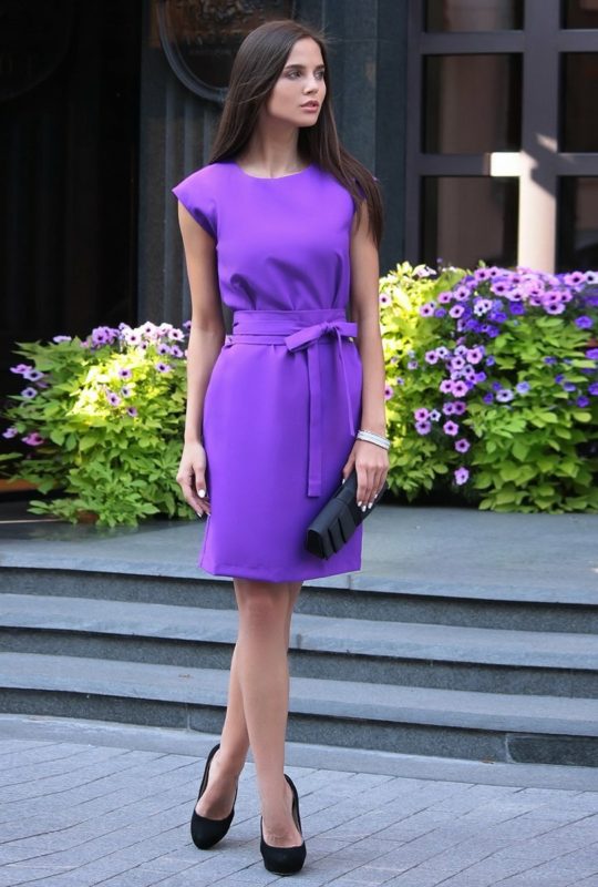 Girl in a purple cocktail dress with a bow