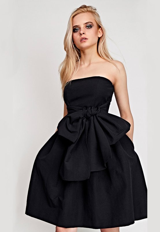 Girl in a black cocktail bandeau dress with a full skirt