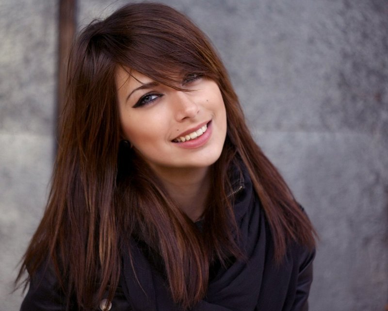 Girl with a gradient haircut and bangs on her side on long hair