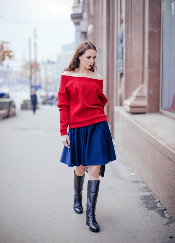 Girl in a sweater with bare shoulders and a skirt.