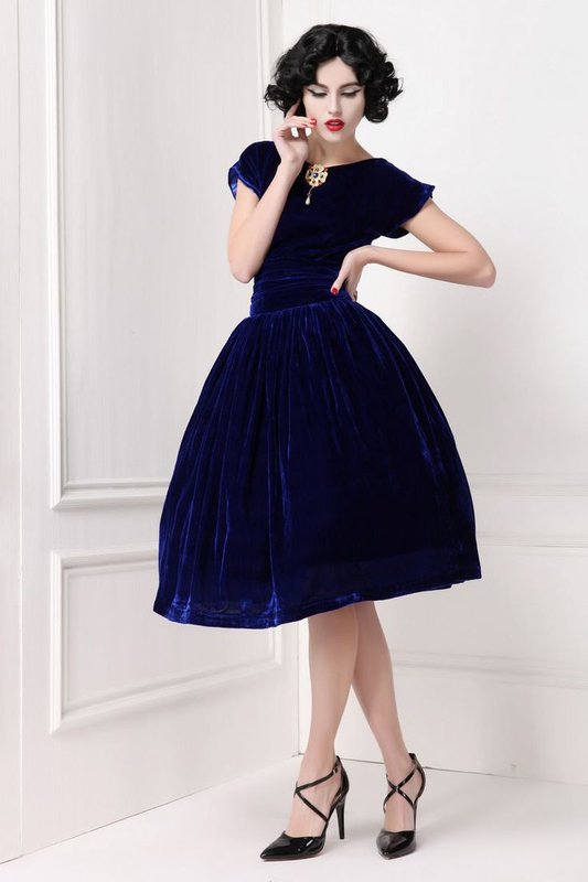 Girl in a dark blue velvet cocktail dress