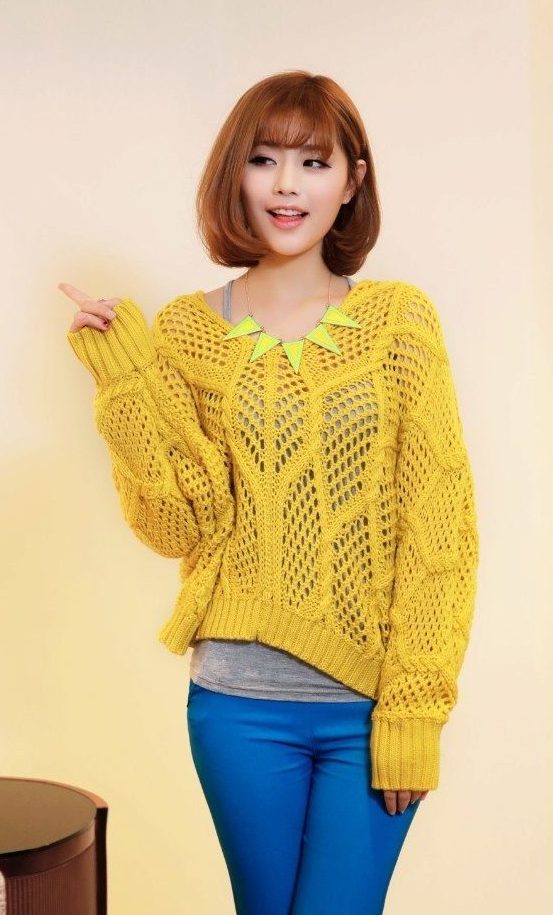 Girl in a lemon sweater and blue trousers.