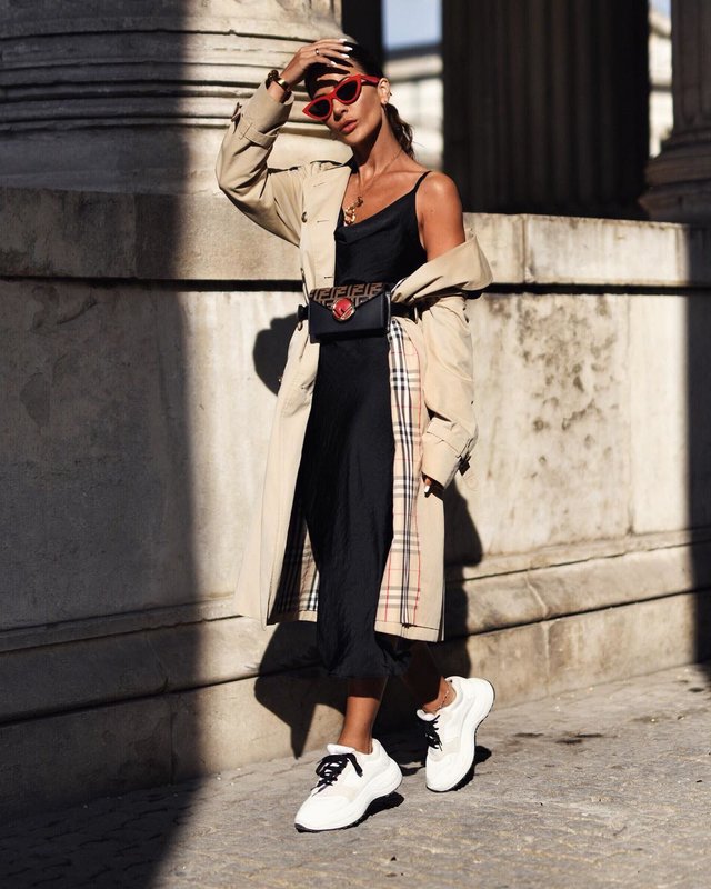 A girl in bulky sneakers combined with a dress