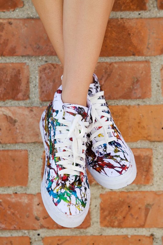 Girl in sneakers with artistic painting