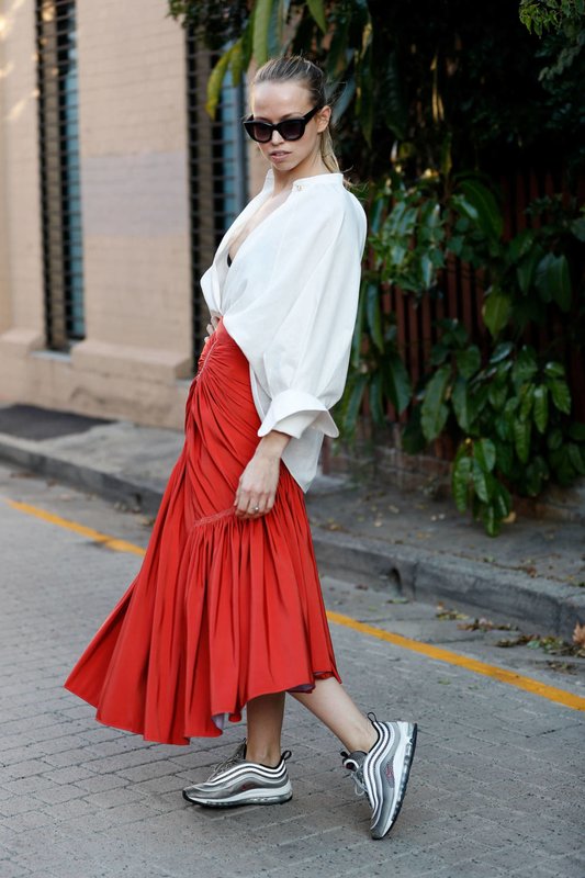 Girl in sneakers and a skirt