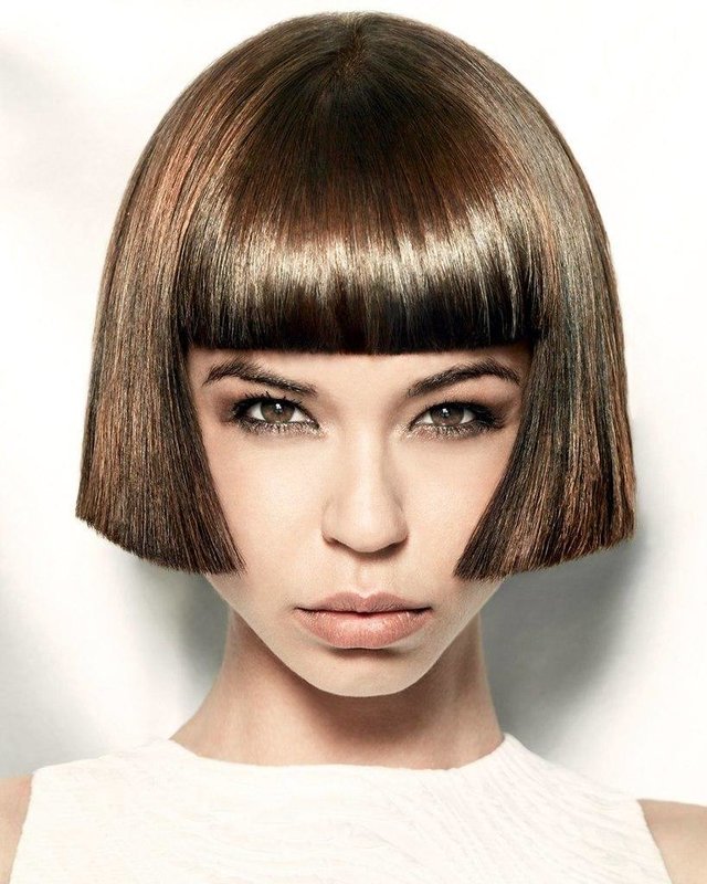 Girl with a straight cut haircut and medium length bangs