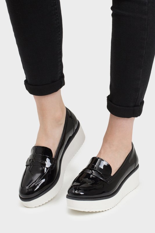 Girl in varnish platform loafers