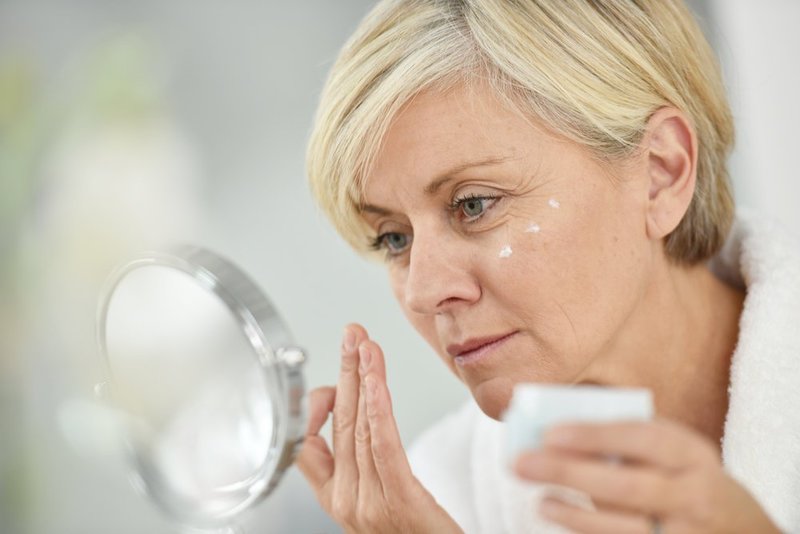 Woman nourishes face cream