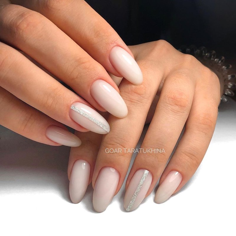 Long almond-shaped nails and milk manicure