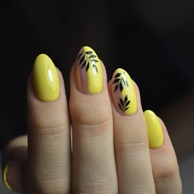 Tropical design on yellow manicure.