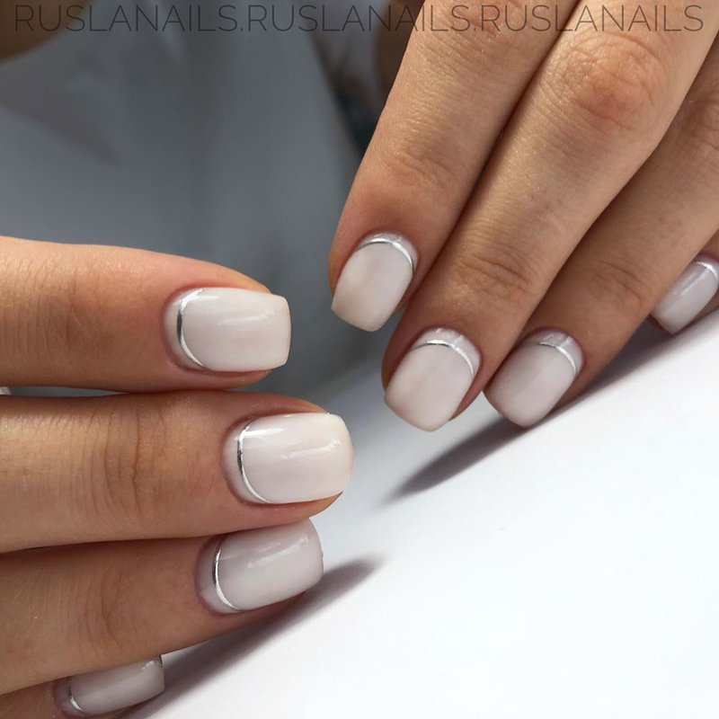 Milk manicure with a silver ribbon