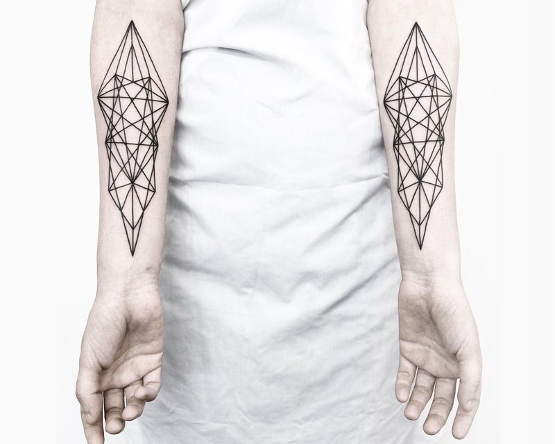 Geometric tattoos on the arms