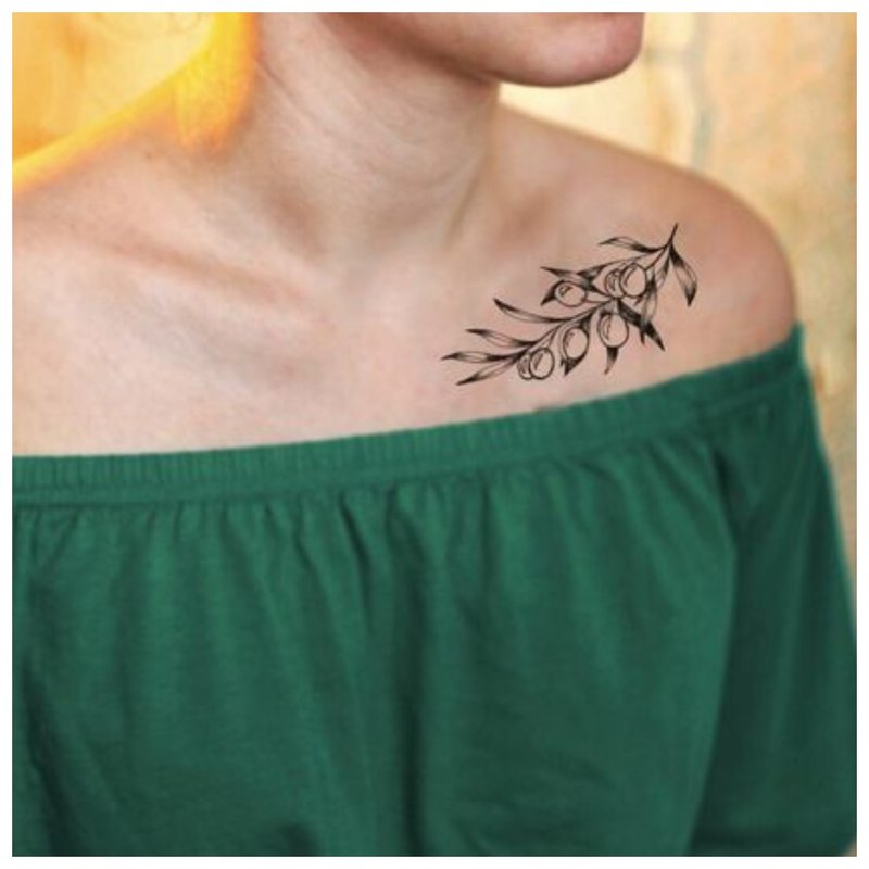 Tattoo sprig of a girl on the collarbone