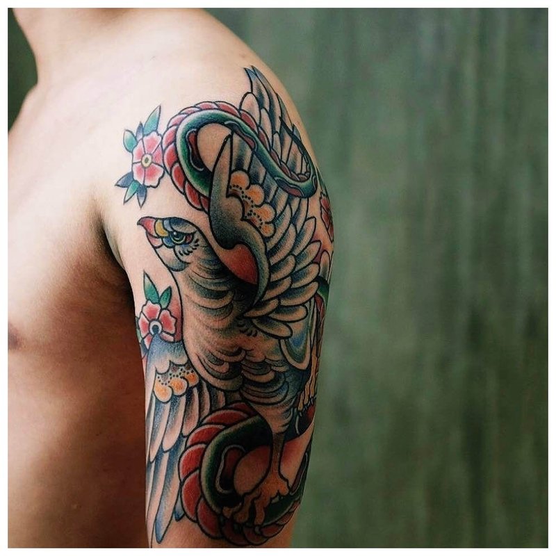 Tattoo with a bird on his shoulder