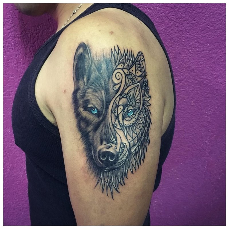 Mix of styles - a wolf tattoo on a man’s arm