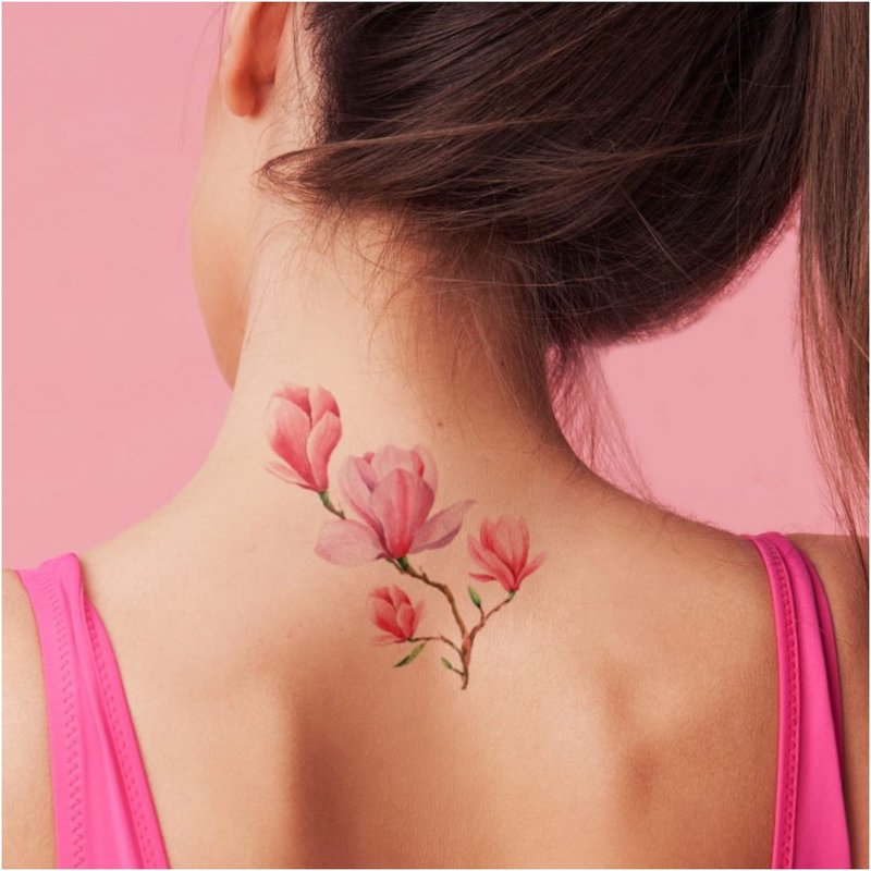 Delicate flower tattoo on the back of the head