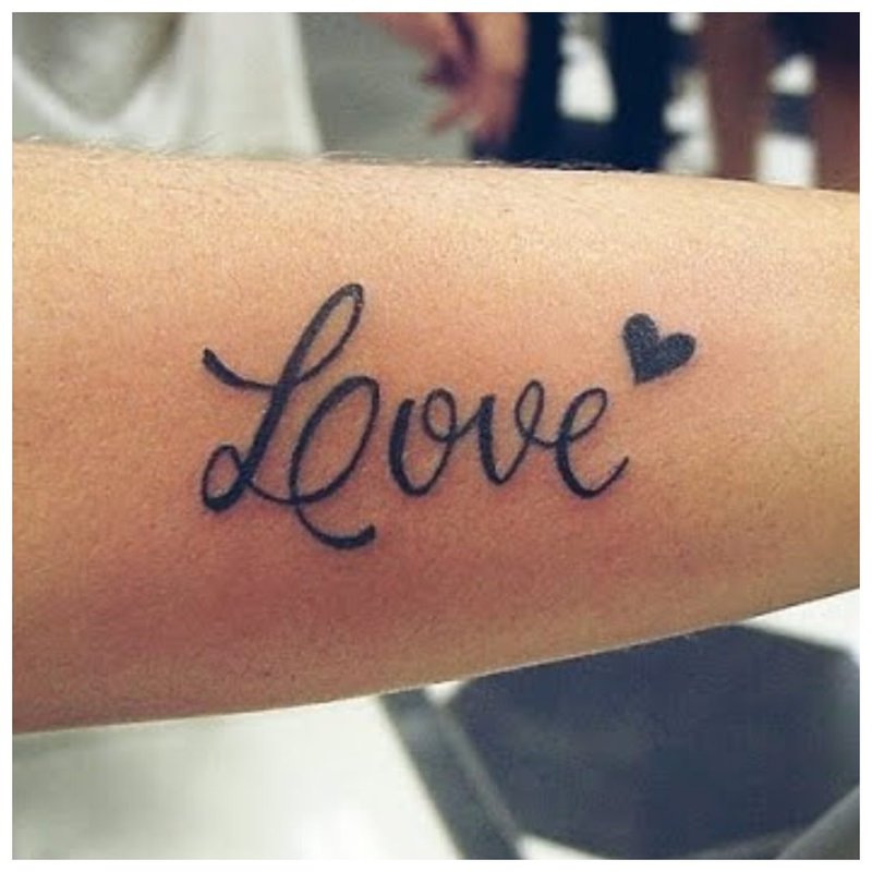 Inscription love on tattoo hand