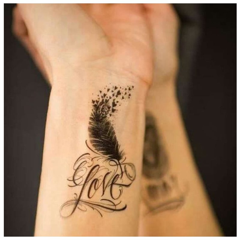 Tattoo inscription with feather