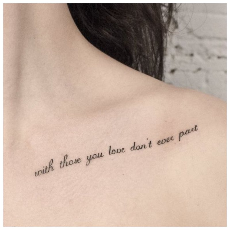 Tattoo inscription on collarbone