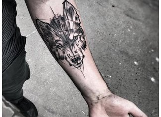 Wolf tattoo on a man’s hand