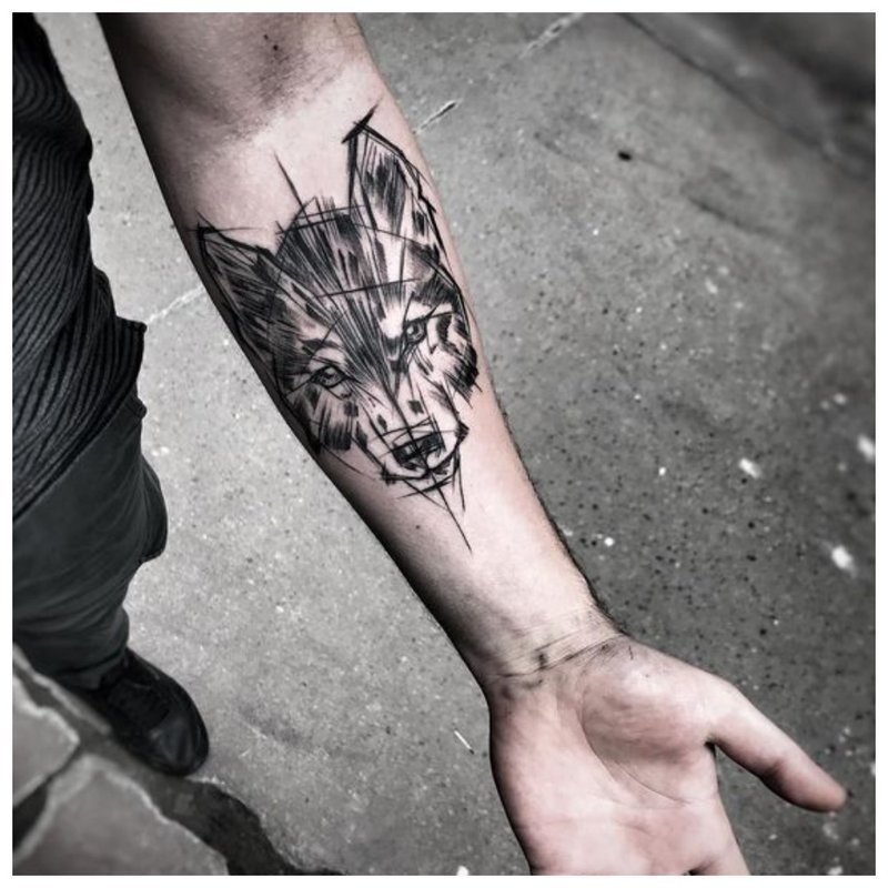 Wolf tattoo on a man’s hand