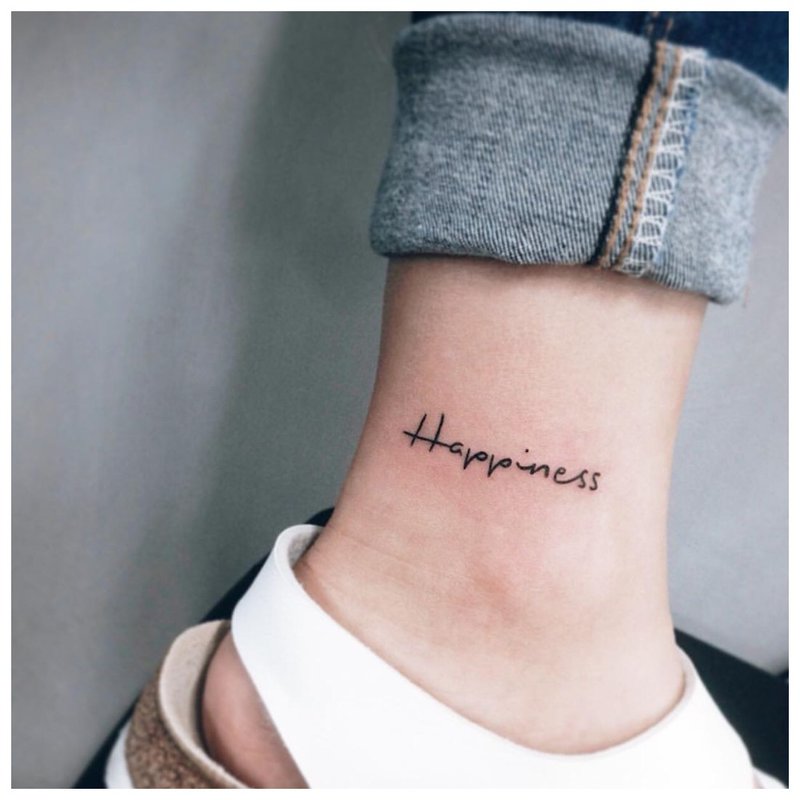 Happiness tattoo inscription in English