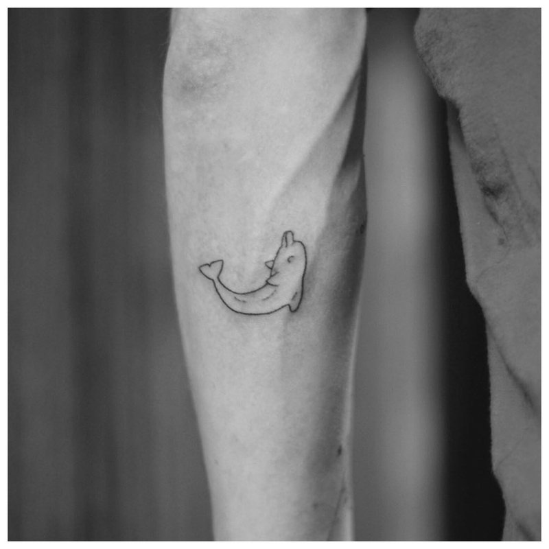 Small fish - tattoo on a man's forearm