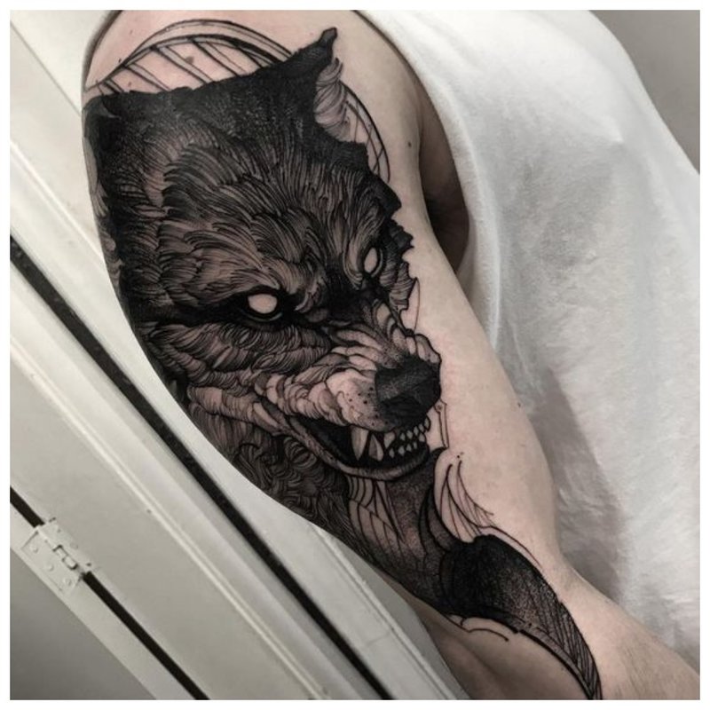 Wolf tattoo on a man’s hand