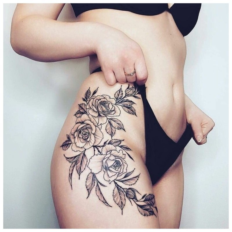 Beautiful flower tattoo on the hip