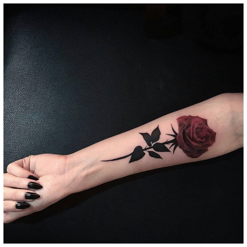 Rose on a girl’s hand - tattoo