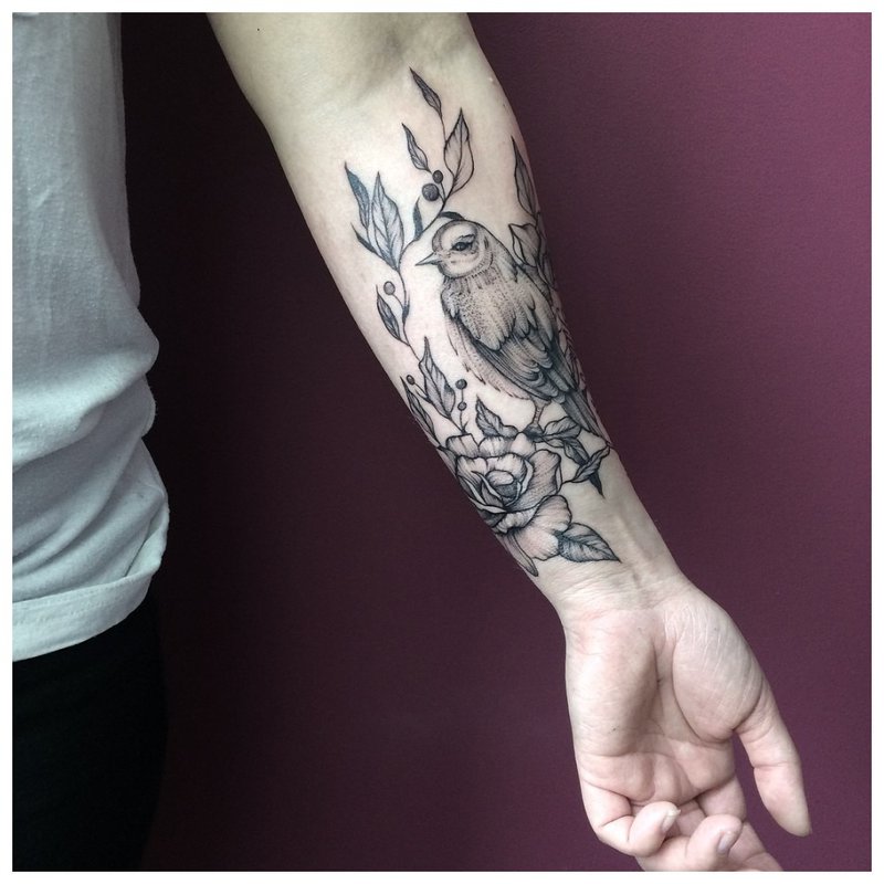 Bird forearm tattoo on men