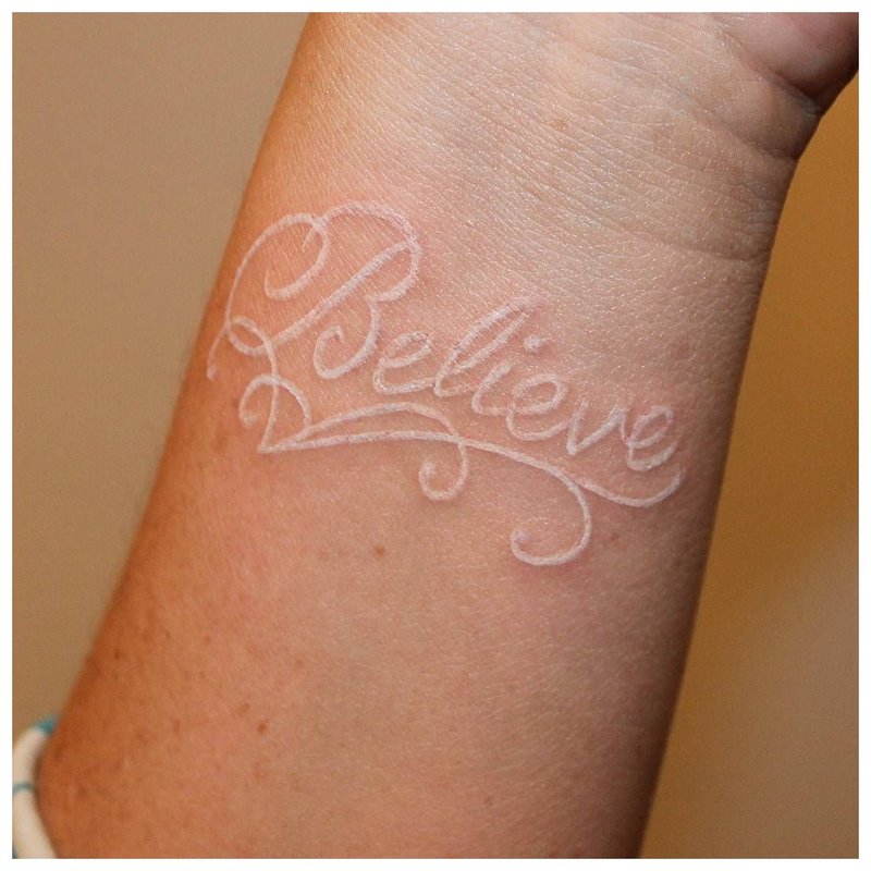 White lettering tattoo