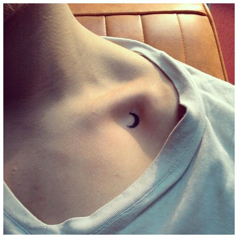 Tender moon tattoo on the collarbone