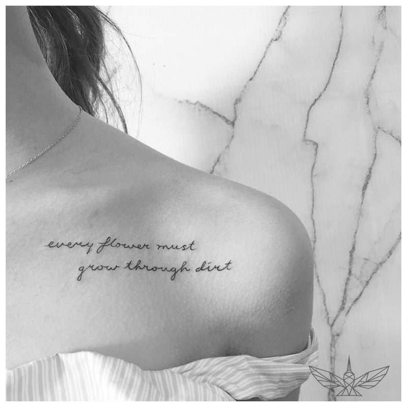 Beautiful tattoo inscription under the collarbone