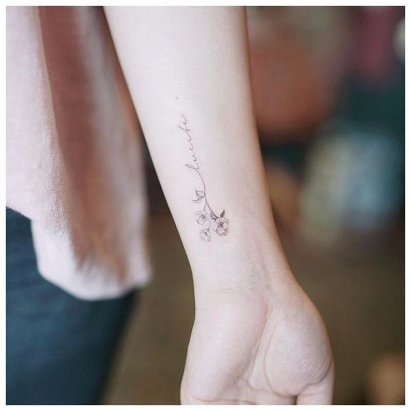 Lettering with flower - tattoo on the wrist