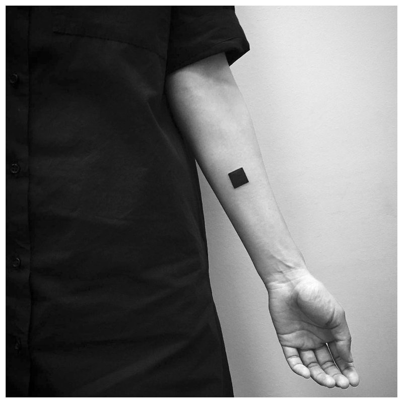 Simple black square - tattoo on the arm of a man