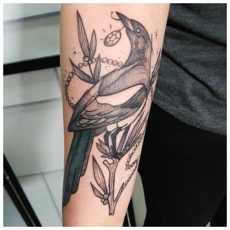 Bird forearm tattoo on men