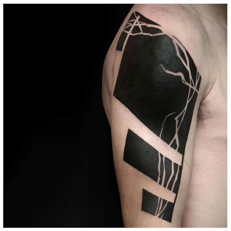 Black shoulder tattoo