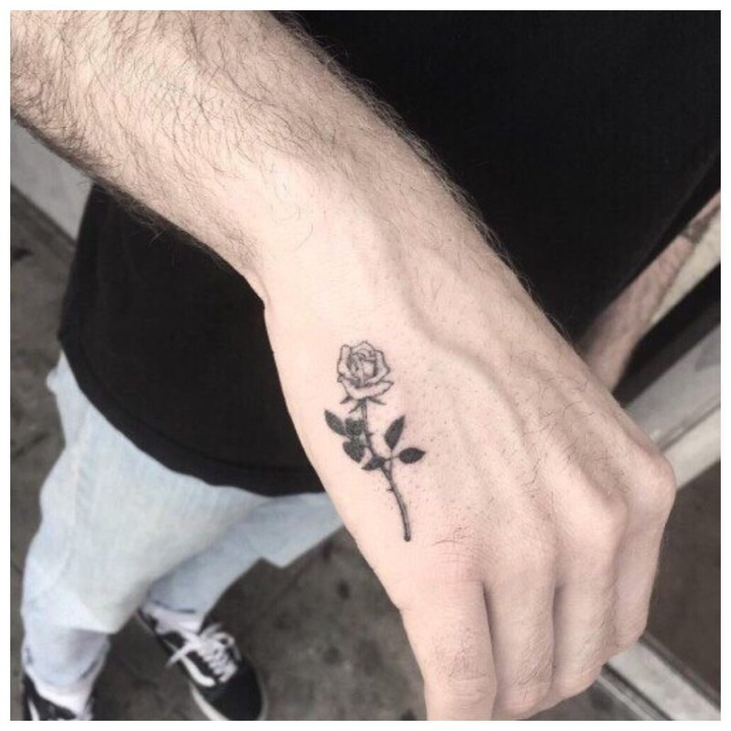 Little rose - tattoo on a man’s hand