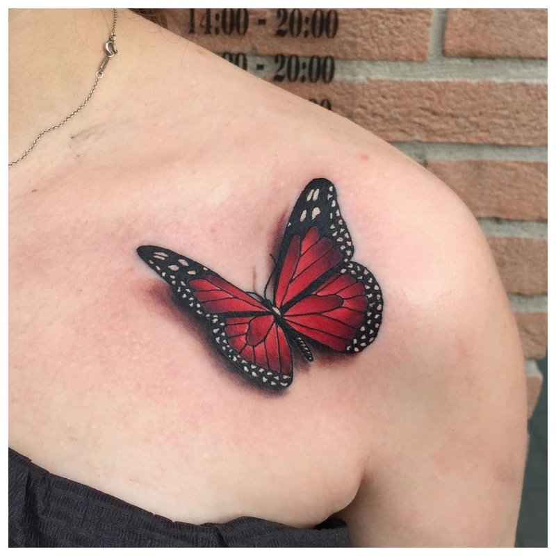 Bright butterfly on the collarbone - tattoo