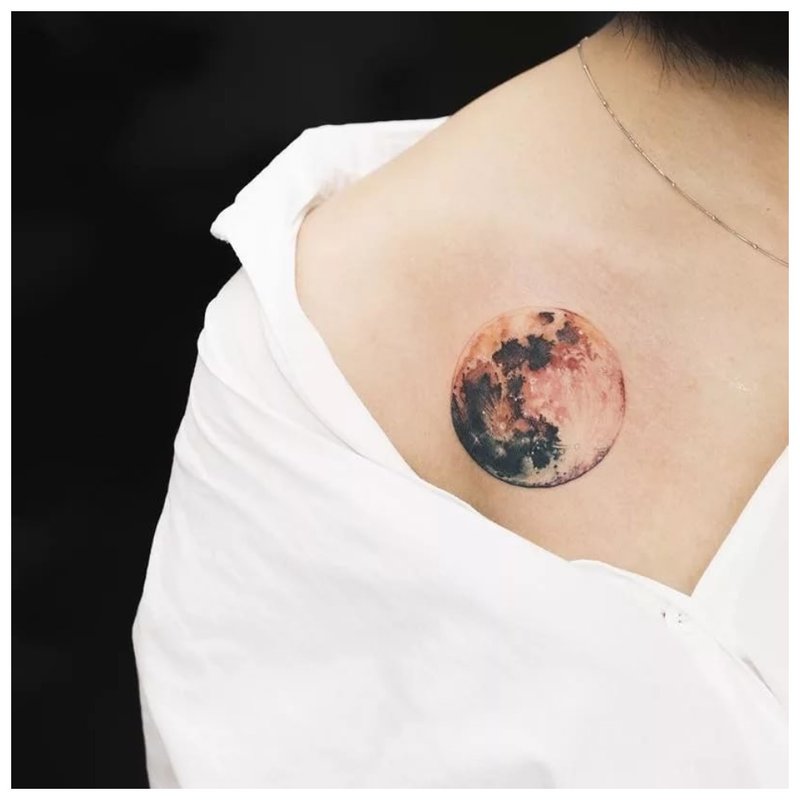 Large color moon tattoo on the clavicle