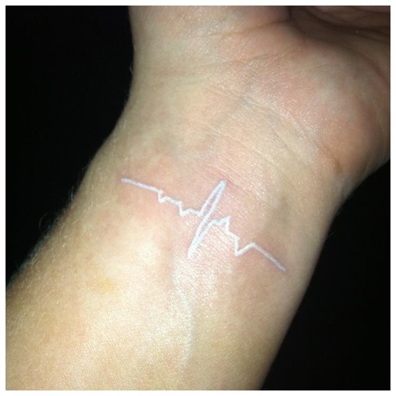 White tattoo in the form of a pulse sign