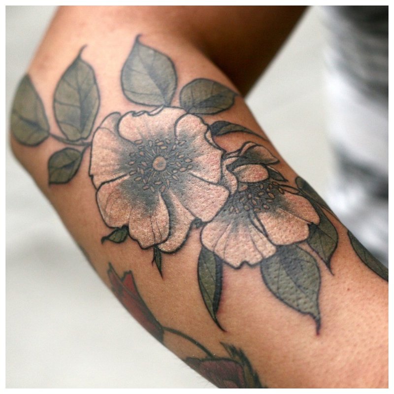 Large flower tattoo on the arm of a girl